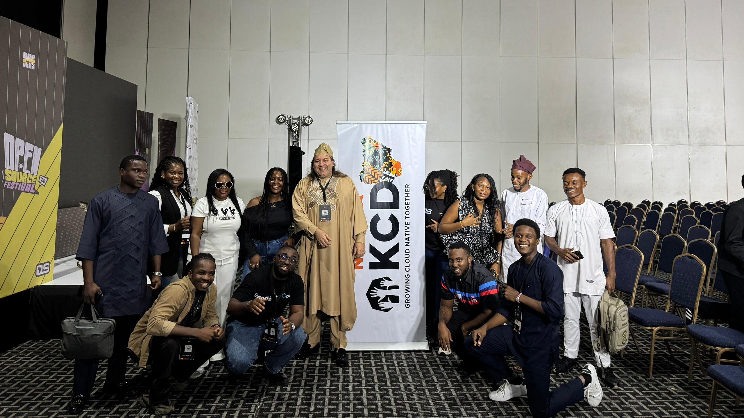 KCD Nigeria 2025 organizers gathered around the KCD Nigeria banner at the event venue